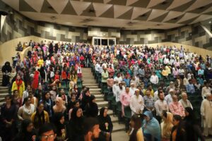 Members-of-community-respecting-national-anthem-during-an-event